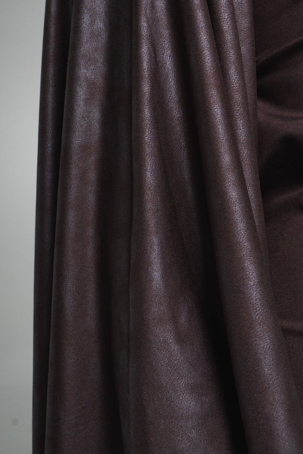 Close-up of brown fabric with a plain background