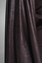 Close-up of brown fabric with a plain background